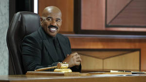 Steve Harvey Portraying Authority In A Classy Black Suit Wallpaper