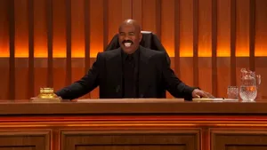 Steve Harvey Smiling In A Formal Suit Wallpaper