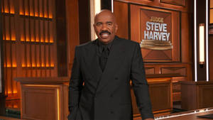 Steve Harvey With A Brown Backdrop Wallpaper