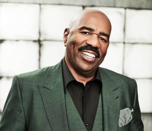 Steve Harvey With Black And Green Suit Wallpaper