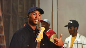 Steve Lacy Singing While Holding Guitar Wallpaper