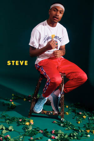 Steve Lacy Sportwear Sitting On Stool Wallpaper