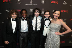 Stranger Things Cast In Glamorous Attires Wallpaper