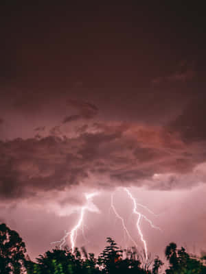 Streaking Through The Sky, This Magnificent Red Lightning Is A Sight To Behold. Wallpaper