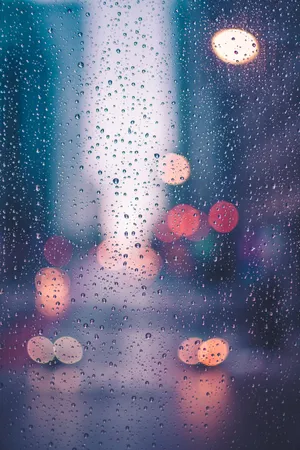 Street Lights Gleaming Through Sparkling Raindrops Wallpaper