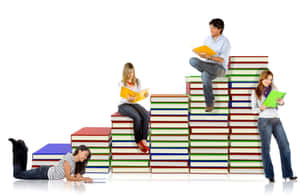 Students Studyingon Stackof Books Wallpaper