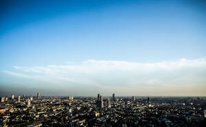 Stunning Skyline - City Braced Against A Dazzling Sky Wallpaper