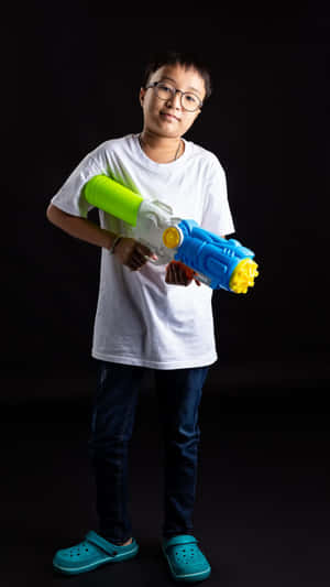 Stylish Boy With Water Gun Wallpaper