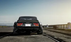 Stylish Red Datsun In An Urban Setting Wallpaper