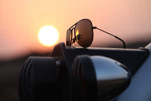 Stylish Sunglasses On A Table By The Beach Wallpaper