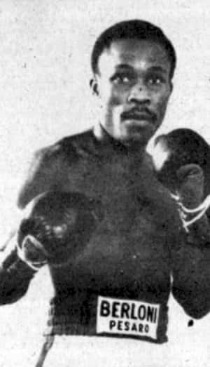 Sumbu Kalambay In A Boxing Match, Showcasing His Intensity And Focus In The Ring Wallpaper