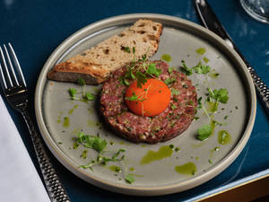 Sumptuous Steak Tartare Adorned With A Fresh Egg Yolk Wallpaper