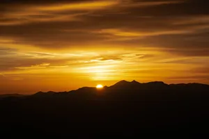 Sun Hd Setting Behind Mountain Ranges Wallpaper