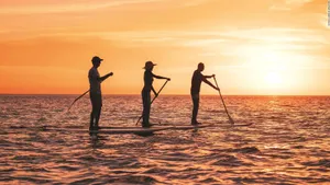 Sunset Paddleboarding Wellness Activity Wallpaper