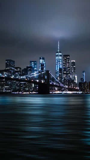 Take A Stroll Through The Vibrant And Bustling Streets Of New York City At Night. Wallpaper