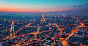 Take In The Evening City Lights Of Paris From A Rooftop View Wallpaper