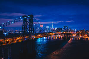 Take In The Sparkle And Grandeur Of The Brooklyn Bridge At Night Wallpaper