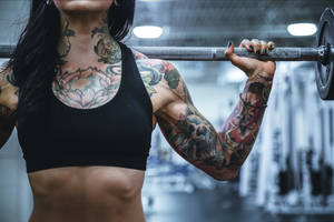 Tattooed Woman With Barbell Wallpaper