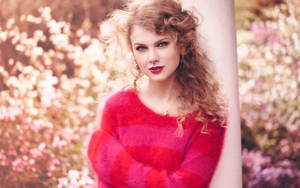 Taylor Swift Rocking Out In A Pink-red Outfit Wallpaper