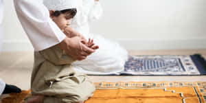 Teaching A Muslim Boy Baby Wallpaper