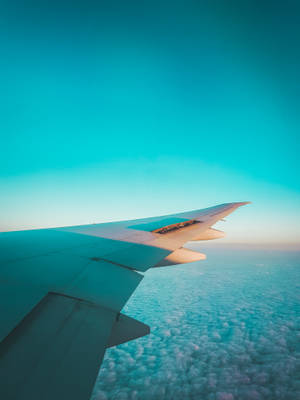 Teal Sky And Airplane Wing Wallpaper
