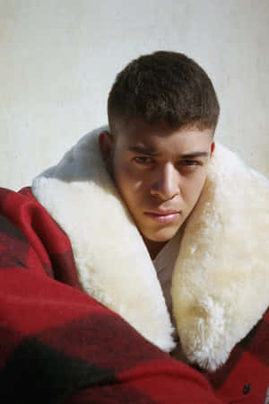 Teen Boyin Red Coatwith Fur Collar Wallpaper