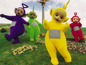 Teletubbies Danicng On Flower Field Wallpaper