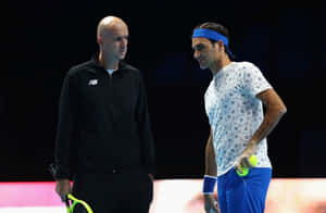 Tennis Coachand Player Strategy Discussion Wallpaper