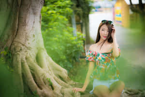 Thai Girl Next To Large Tree Wallpaper