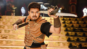 Thalapathy Vijay Exhibiting Fierce Look With A Sword Wallpaper