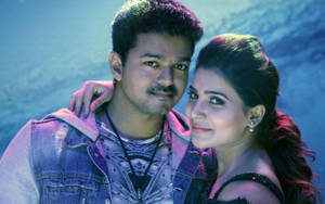 Thalapathy Vijay With A Female Co-star In A Dramatic Movie Scene Wallpaper