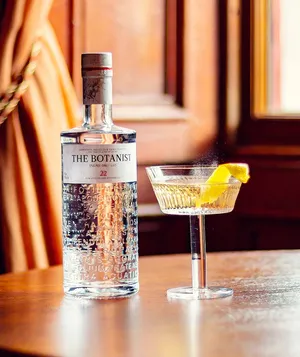 The Botanist Gin Alcoholic Drink On Table By The Window Wallpaper