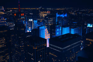 The Bustling City Of New York Glows With Blue Light. Wallpaper