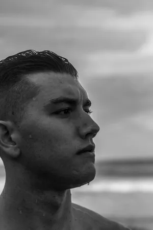 The Charismatic Gaze: Side-profile Of A Handsome Man In B&w Wallpaper