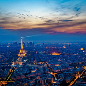 The City Of Love Shines Bright At Night Wallpaper