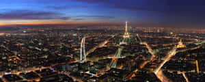 The Eiffel Tower In The Moonlight At Night In Paris, France Wallpaper