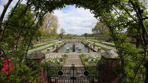 The Iconic Arch Entrance Leading Into Lush Green Gardens Of Kensington Palace. Wallpaper