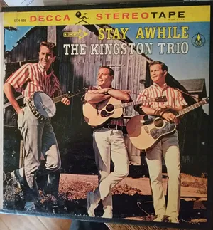 The Kingston Trio Posing With Their Album
