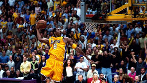 The Legendary Kobe Bryant Showing Off His Signature Dunk Move Wallpaper