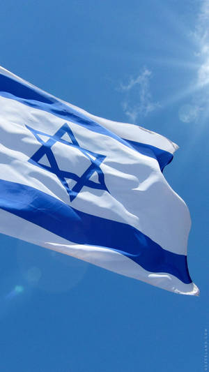The National Flag Of Israel Majestically Waving In The Wind Wallpaper