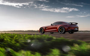 The Unstoppable Power - Amg Gtr On Grass Road Wallpaper