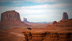 The Wild Wild West: A Cowboy Rides His Horse Into The Sunset. Wallpaper