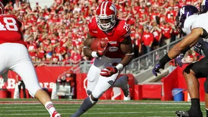 The Wisconsin Badgers Logo Displayed Proudly On A Stadium Field Wallpaper