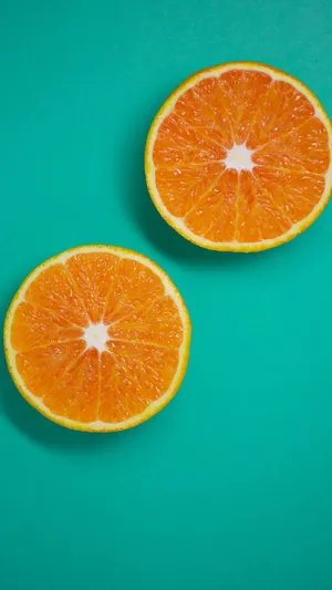 Three Sliced Orange Fruits Wallpaper