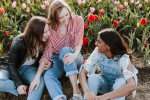 Three Teenage Girls Talking And Laughing Wallpaper