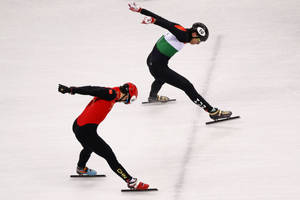 Thrilling Action At Men's 5000m Relay Short Track Speed Skating Wallpaper