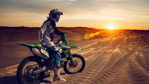 Thrilling Ride With The Monster Dirt Bike Wallpaper