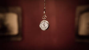 Tiempo Pocket Watch In Blurry Brown Backdrop Wallpaper