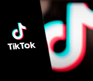 Tiktok Logo With A Black Background Wallpaper