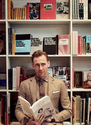Tom Hiddleston In A Library Wallpaper